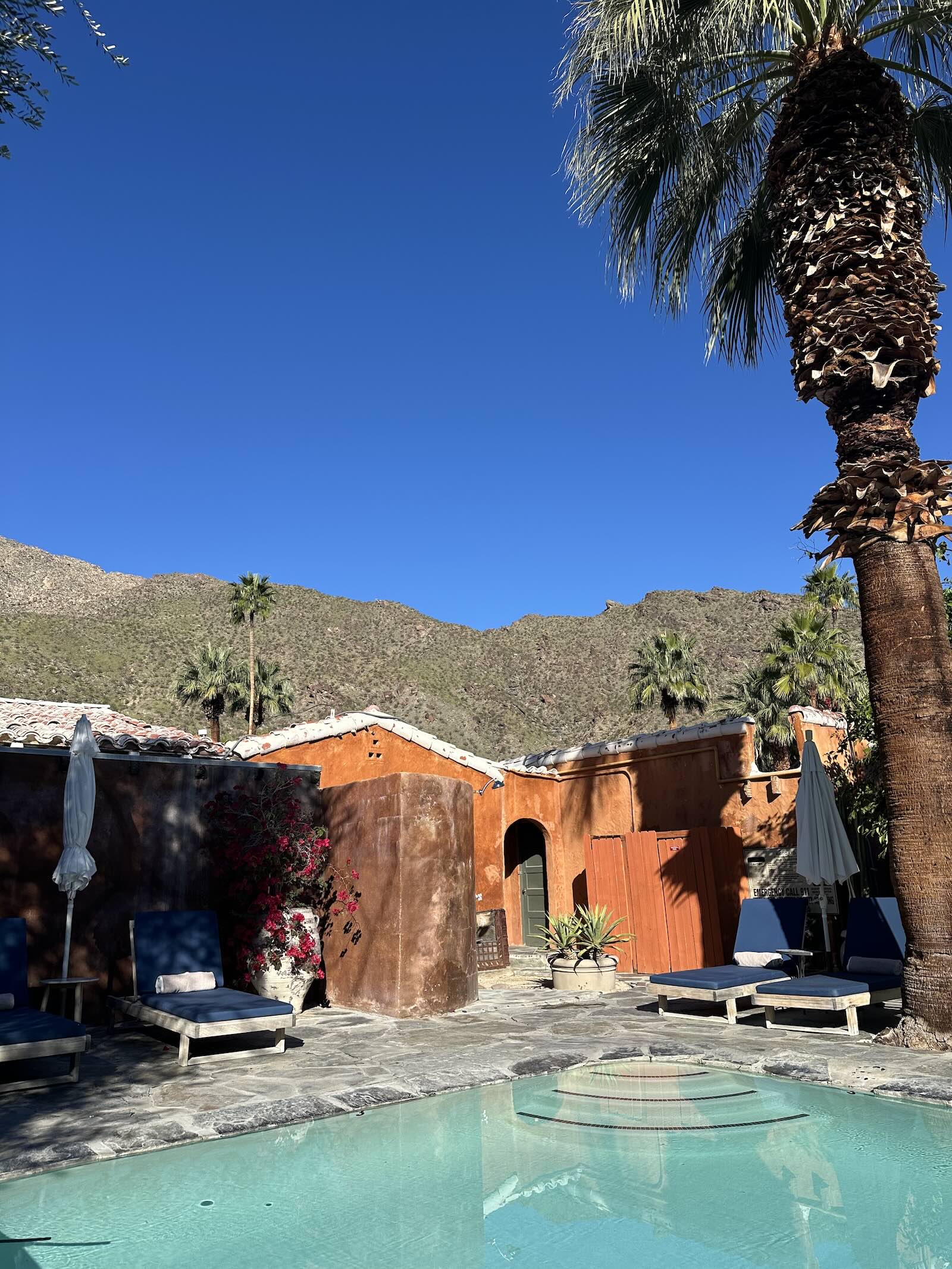 A serene retreat setting with warm desert light and calm pool